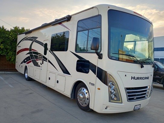 Thor Hurricane Class A motorhome available for rent, parked at dusk